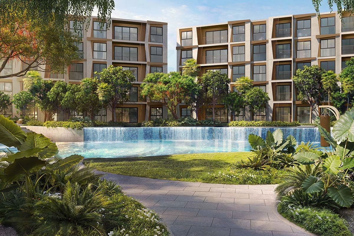 The waterfall between the two pool levels, with a ribbed facade and planting along the bank behind it