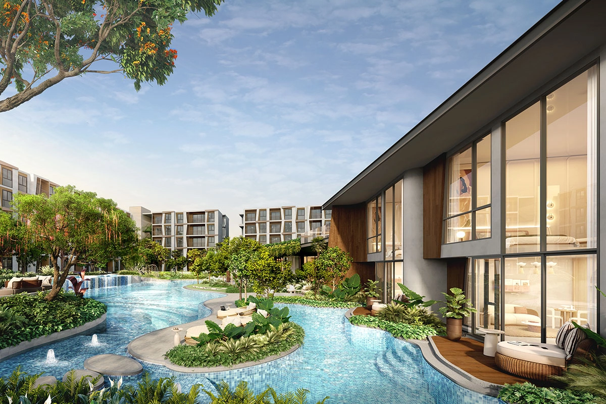 The lagoon pool with planted islands and loungers, and the double-height glazing of a villa on the right