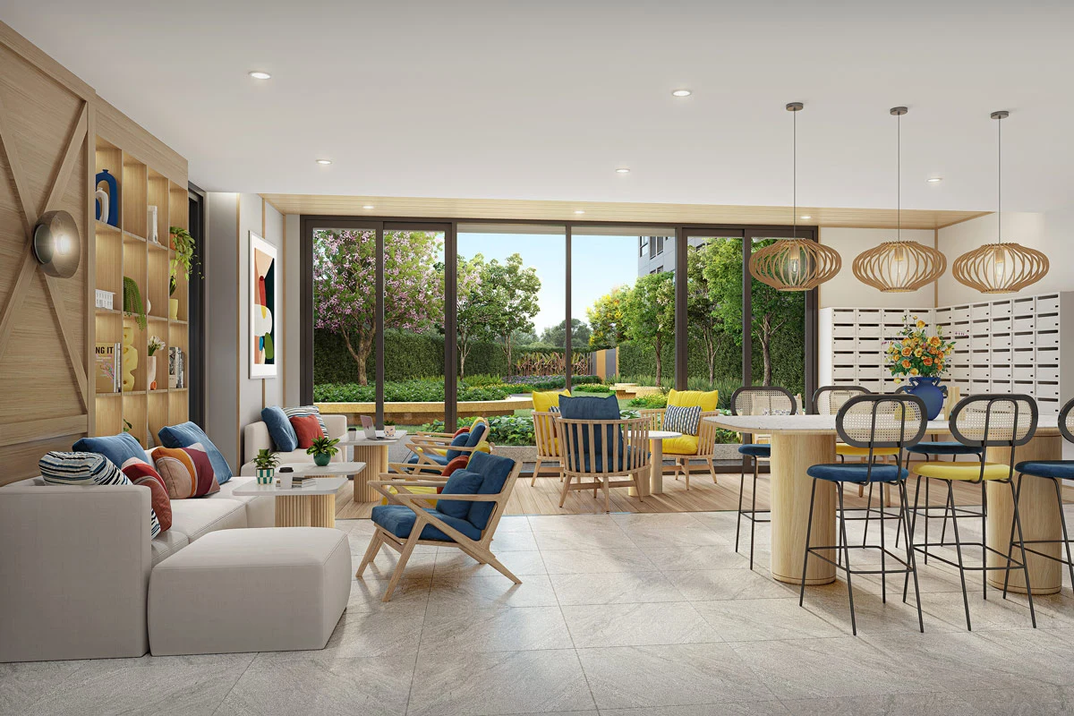 The lobby on the ground floor: a white sofa and armchairs on the left, a bar counter with high stools on the right, a wall of letterboxes and sliding glazing onto the garden