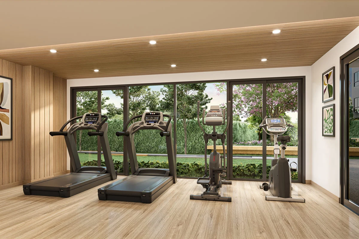 The gym: two treadmills, a cross-trainer and an exercise bike along the glazing, lawn and hedge outside, a slatted ceiling