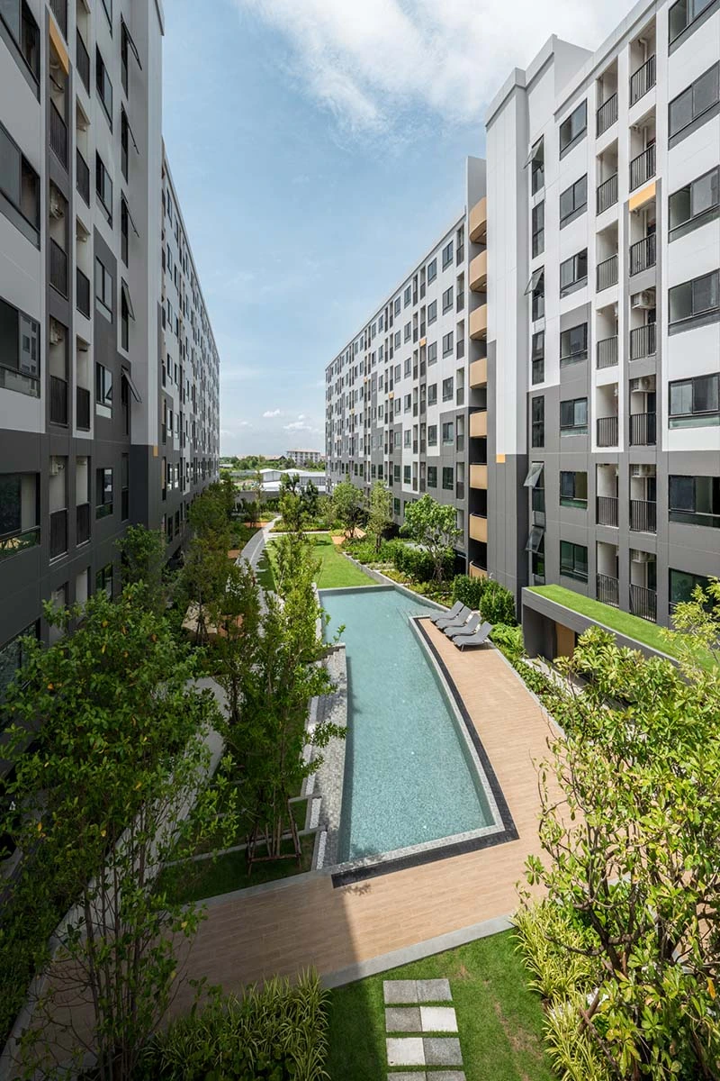 The courtyard between the buildings from an upper floor: the long narrow pool down the middle, lawn and paths to either side, a flat horizon beyond
