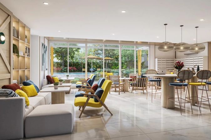 Co-Living Area: диваны и кресла у окон в сад, дальше высокие столы с барными стульями и подвесные плетёные светильники