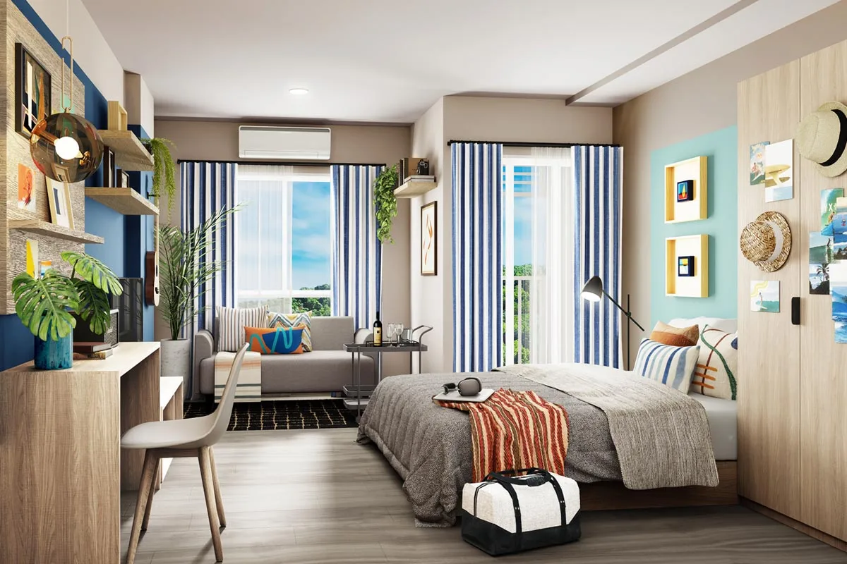 A show unit of a small apartment: bed and sofa in one volume, a desk at the wall, a split air conditioner above the window, curtains on the window and on the full-height opening