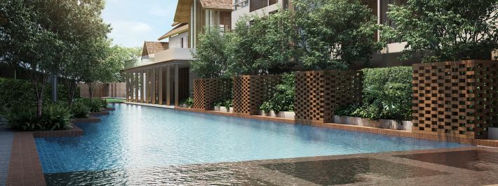 The inner courtyard: a long pool between the buildings, wooden screen panels and the clubhouse's pitched roof at the far end