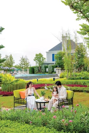The flower garden of the common area, with the clubhouse roof beyond