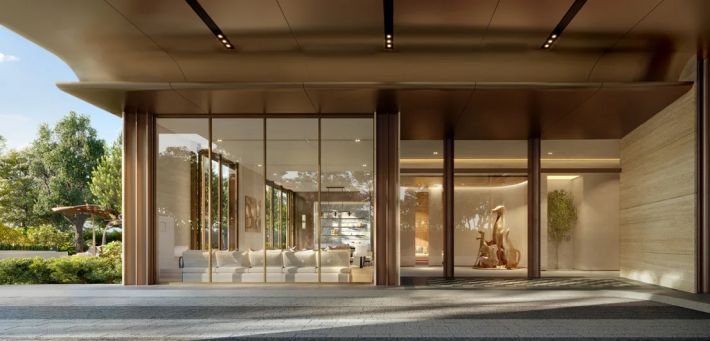 The sheltered drop-off: a glazed vestibule, a timber ceiling and garden to either side