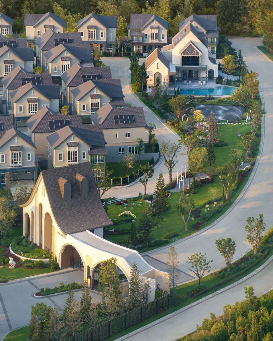 From above: the arched clubhouse, the pool and the rows of houses around them