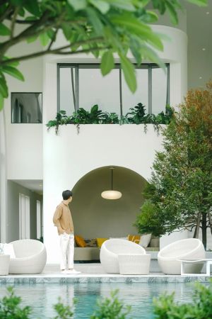 The pool in the clubhouse courtyard, greenery around it