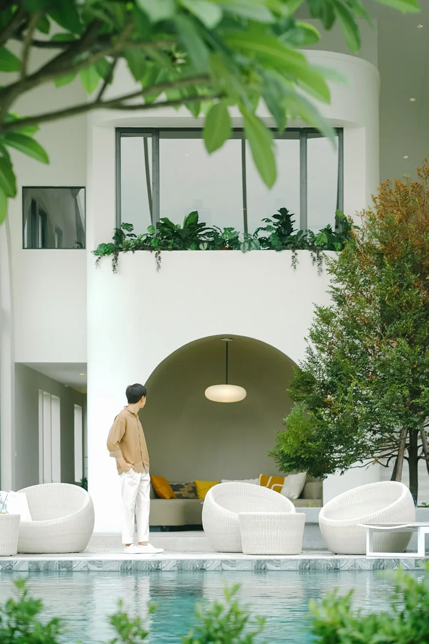 The pool in the clubhouse courtyard, greenery around it