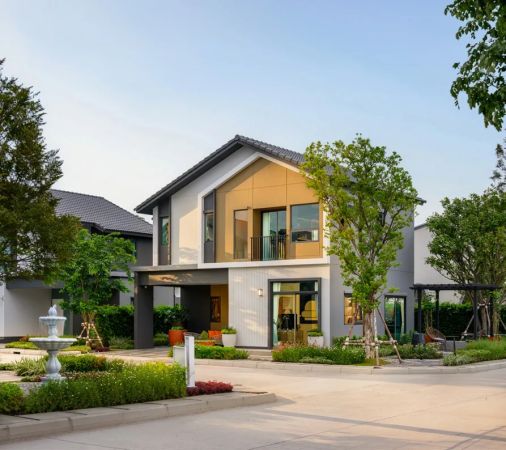 A house from the street: a gabled roof, timber inserts and a front garden