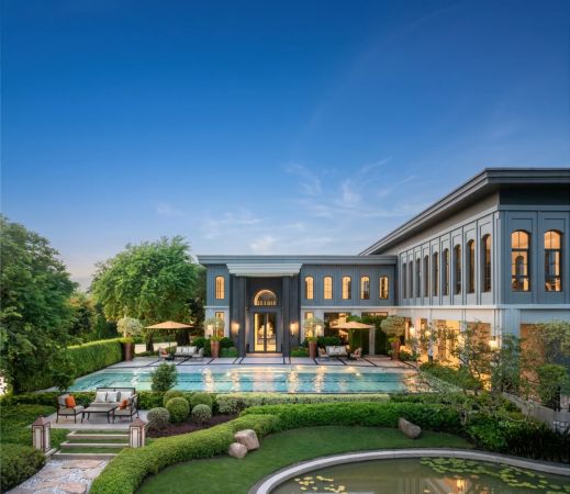 The clubhouse at dusk, the pool and loungers