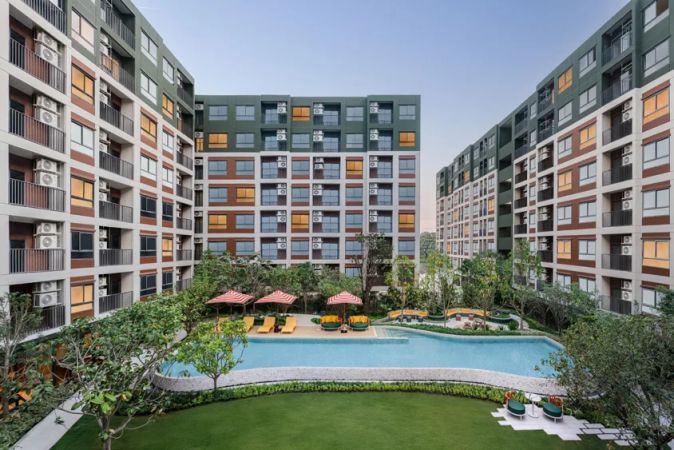 The courtyard pool, the buildings ringing it and the lawn in front of the water