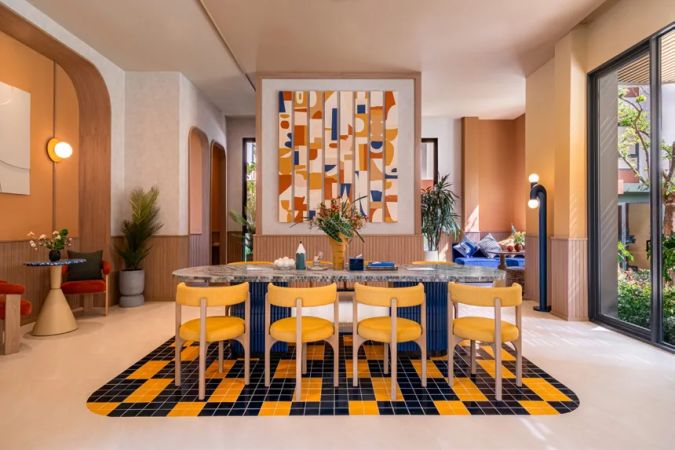 The communal kitchen with its long island and yellow chairs