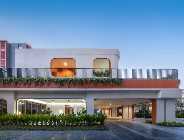 The clubhouse at dusk, its lit terrace above the entrance