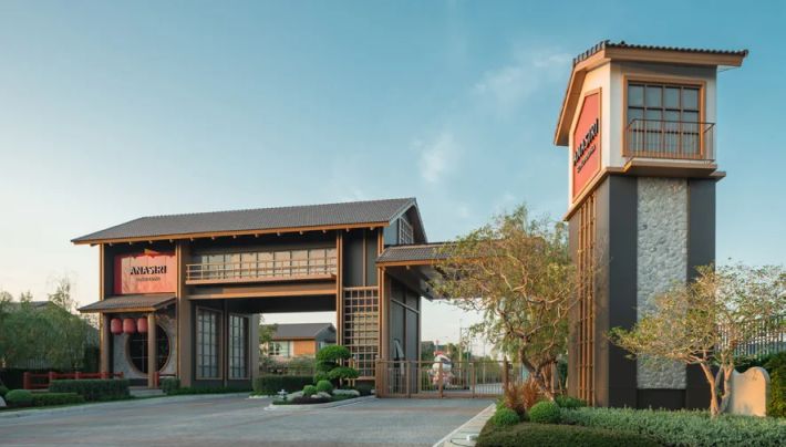 The entrance tower and the development's gate at dusk