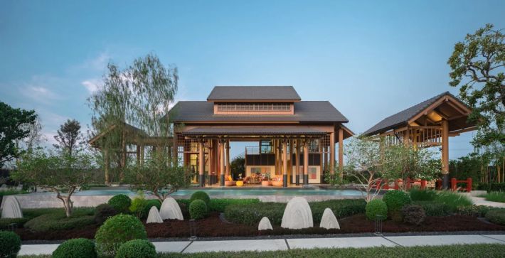 The clubhouse pavilions in a garden of clipped shrubs