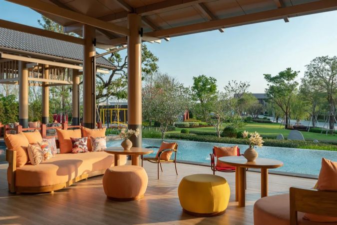 The covered lounge overlooking the pool and the park