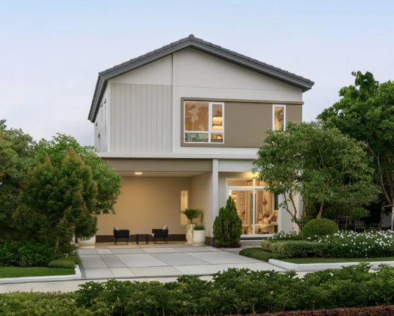 A house with a ground-floor terrace opening onto the lawn