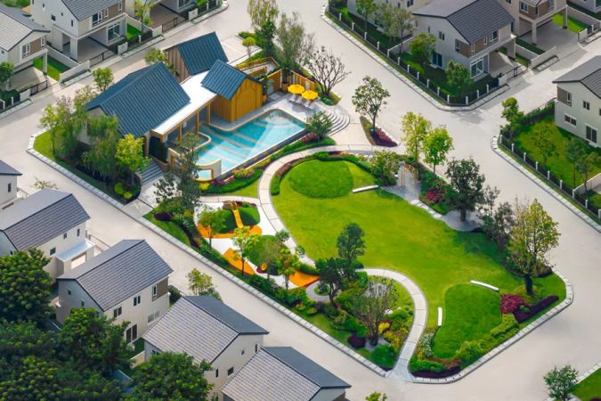 The shared part from above: clubhouse, pool and lawn among the houses