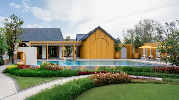The pool by the clubhouse with its yellow pavilion