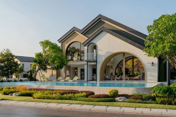 The pool in front of the clubhouse, shrubs along the edge