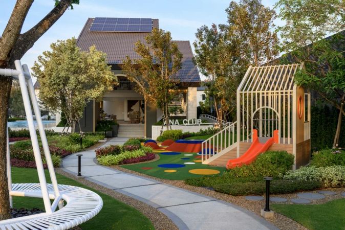 The playground with slide and swings by the clubhouse