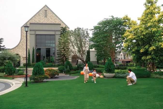 The clubhouse with its tall gable above the lawn