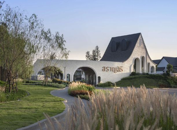 The clubhouse beyond a field of ornamental grasses