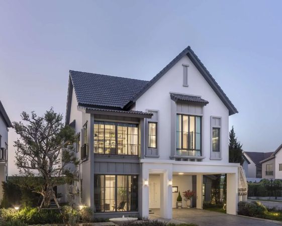 A house with lit windows at dusk