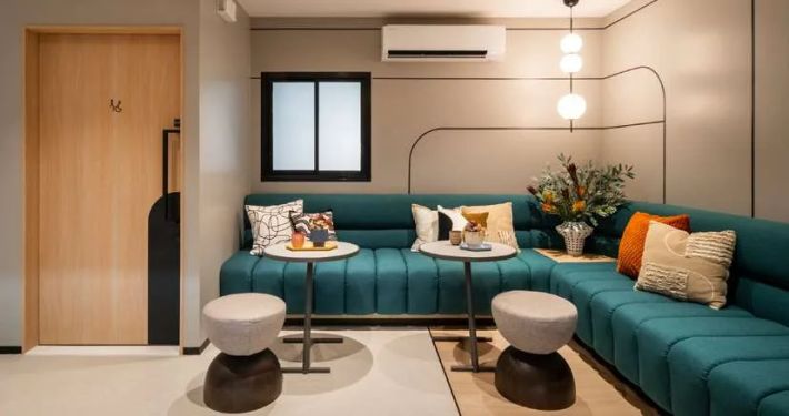The show unit's living room with a turquoise sofa
