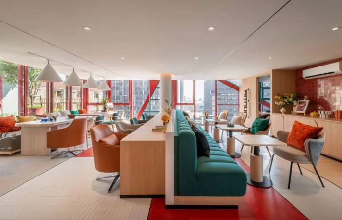 The co-working area with red and turquoise accents