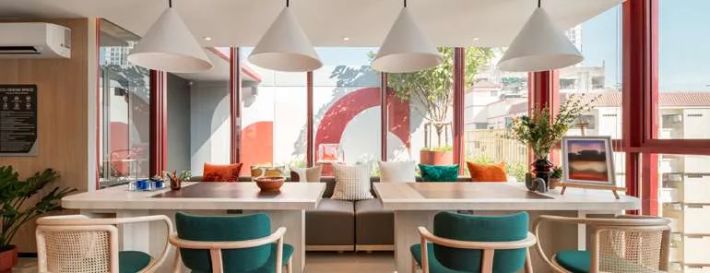 The lounge's long table by the full-height window