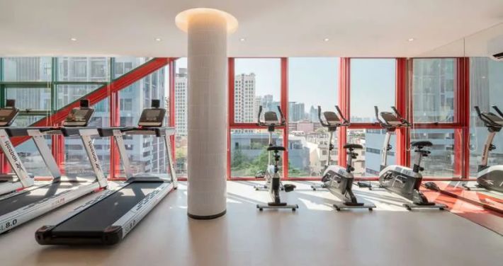 The gym with treadmills and red columns