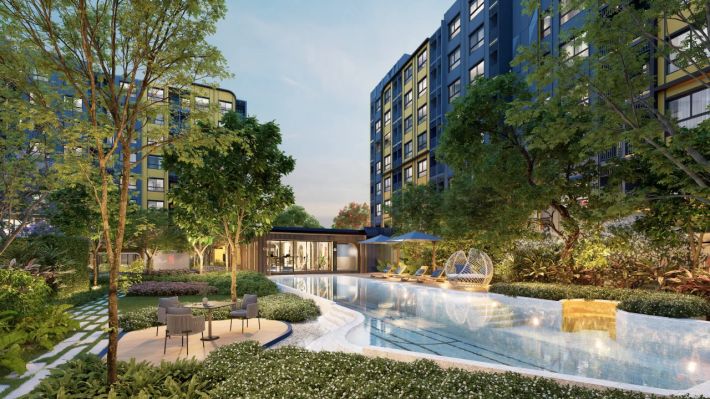 The pool between the buildings and greenery along the water