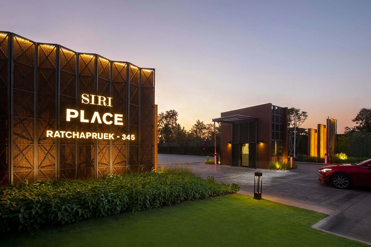 The project sign at dusk