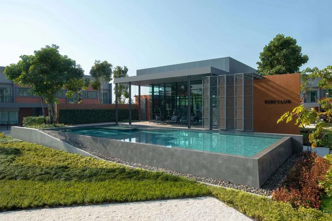 The clubhouse above the long pool