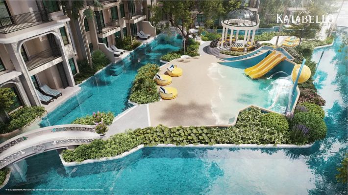 The sand zone by the water: yellow slides, a pavilion and bridges over the pool