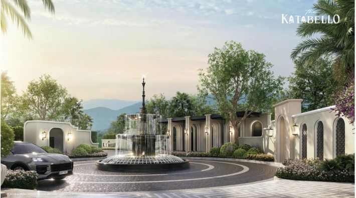 The entrance plaza with a fountain and arcade, hills behind