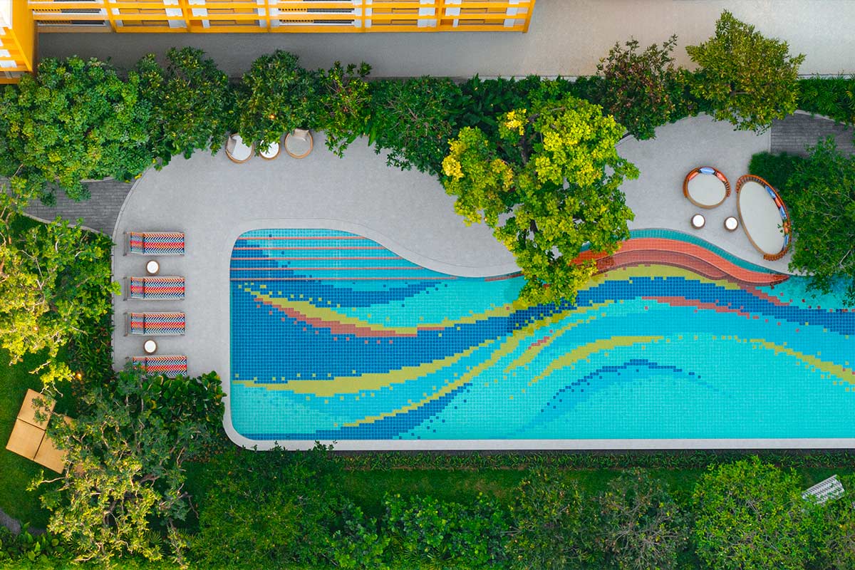 The pool from above: a coloured mosaic wave pattern runs along its floor