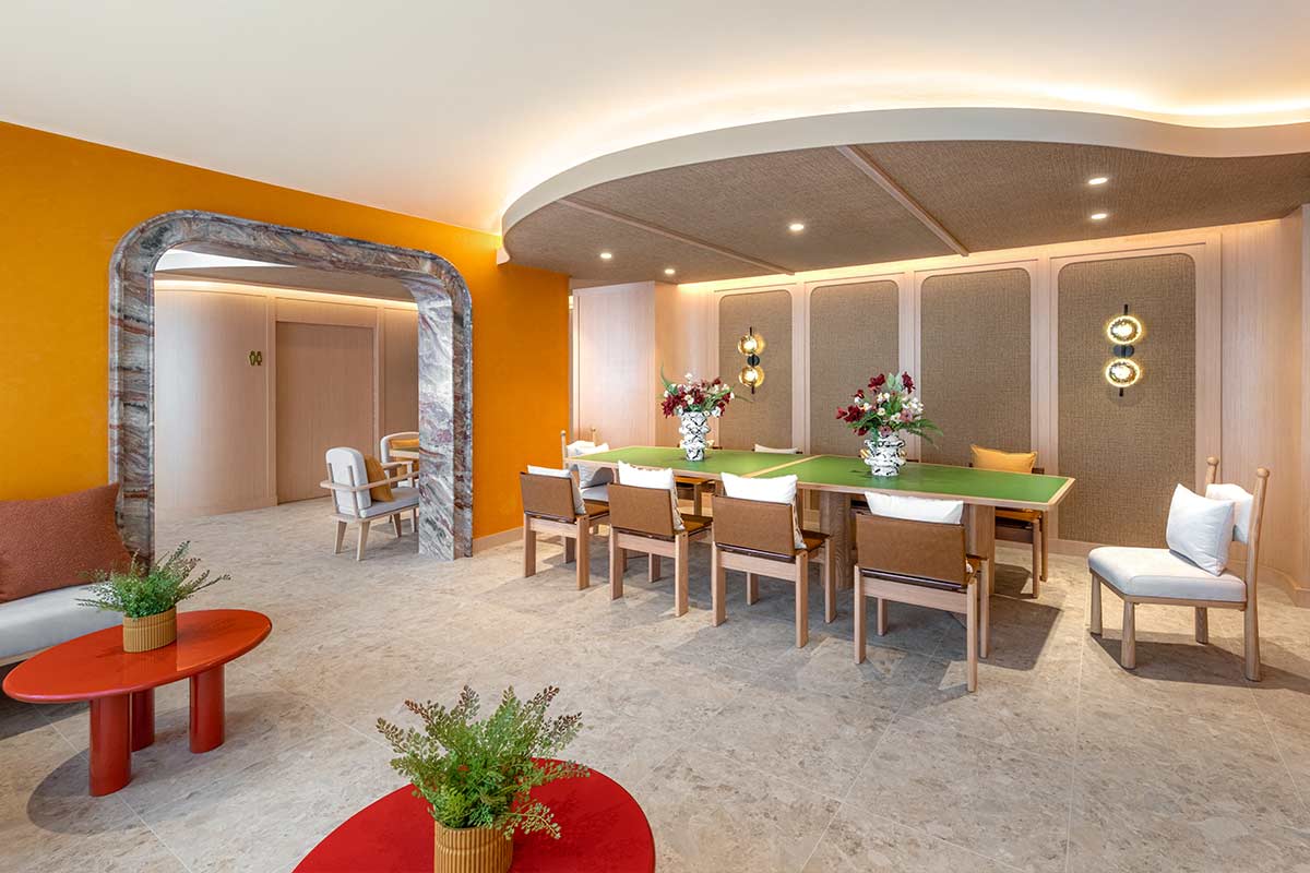 Co-working area: a long shared table for eight under an acoustic ceiling