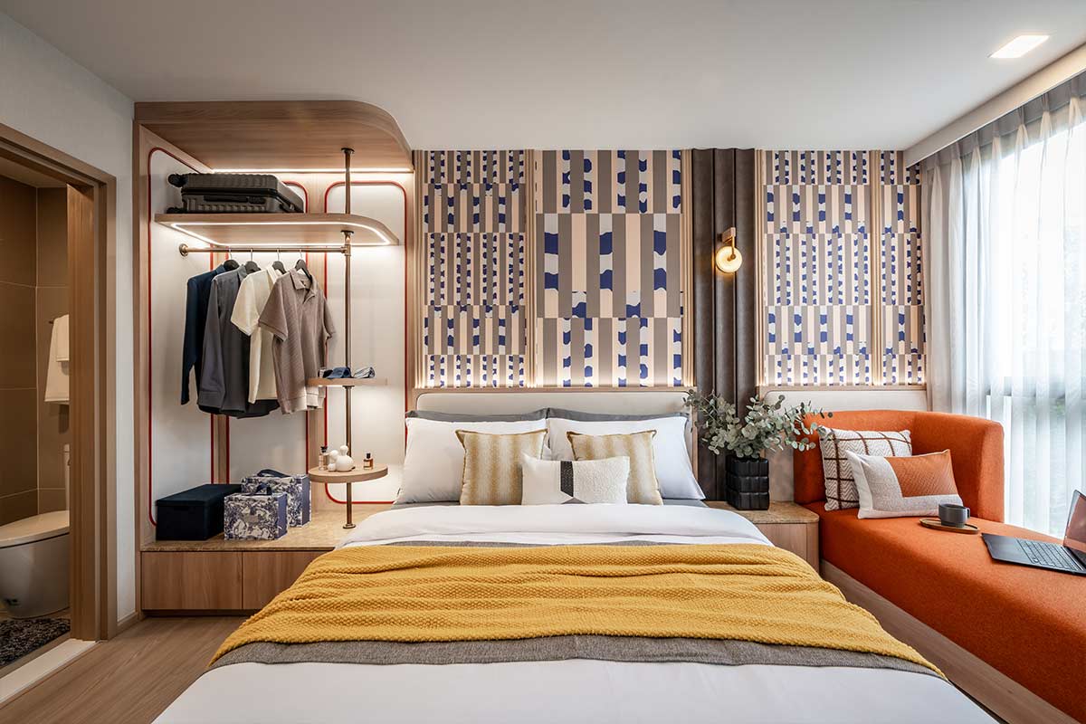Bedroom with an open wardrobe and a daybed by the window