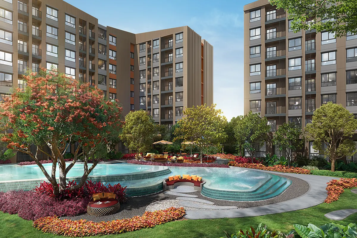 The round jacuzzi beside the pool, surrounded by lawn and flower beds with the buildings behind
