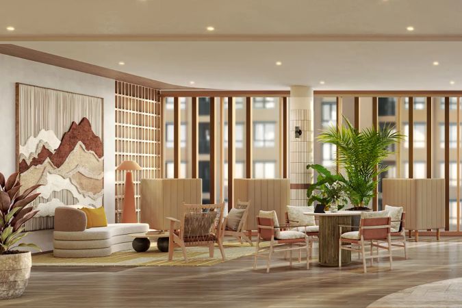 The co-working space: armchairs and a table by the window, high-backed booths and a wall panel