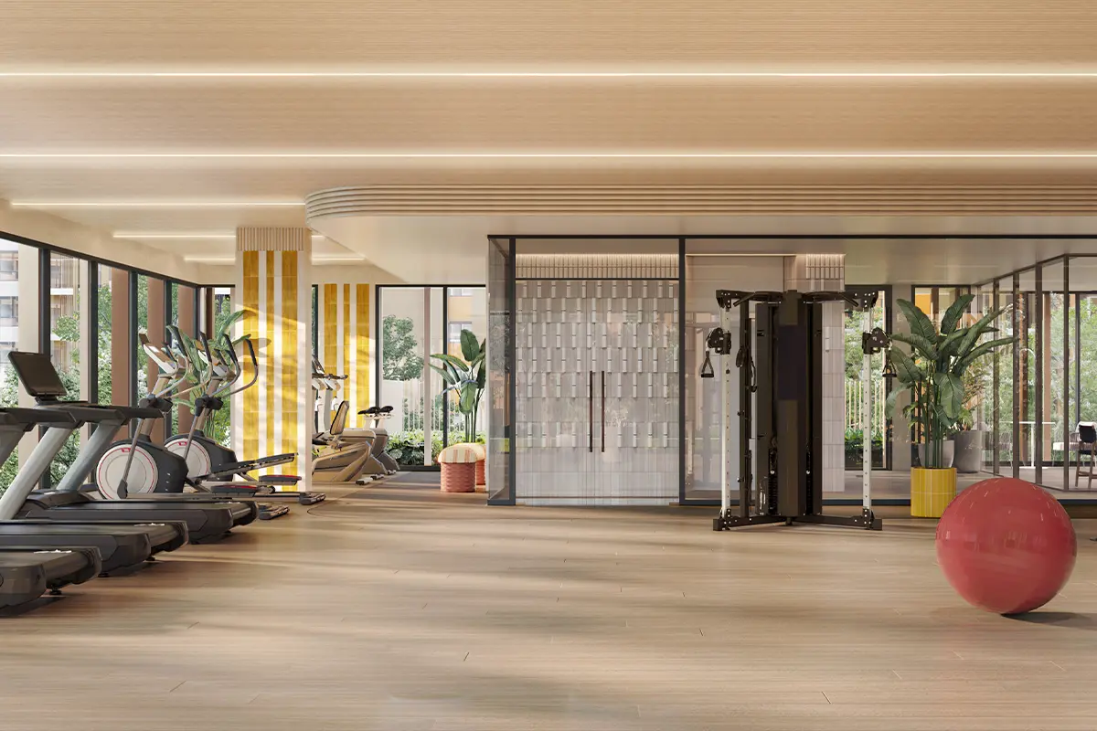 The fitness room: treadmills and exercise bikes by the windows, weight stations and glass partitions beyond