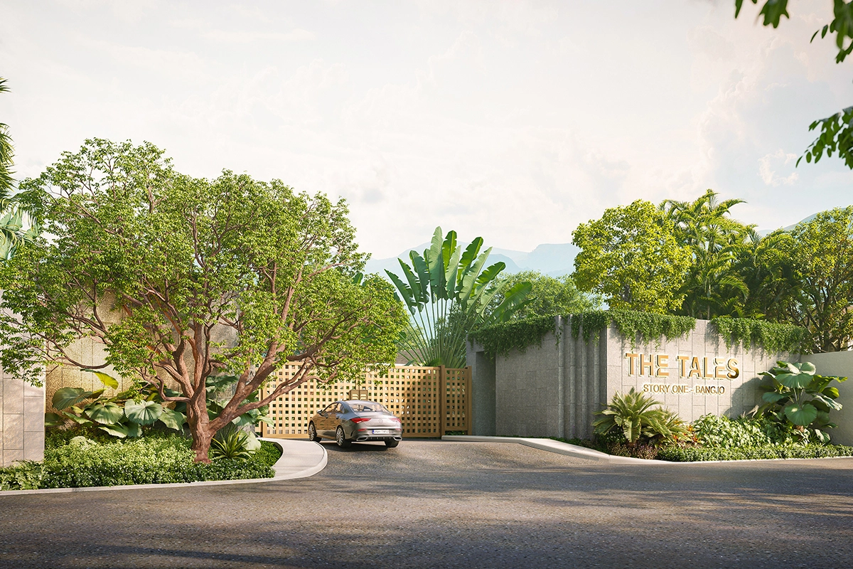The same entrance from the side: a car at the latticed gates, the concrete wall with the project name in gold and trailing ivy on the right, a spreading tree on the left