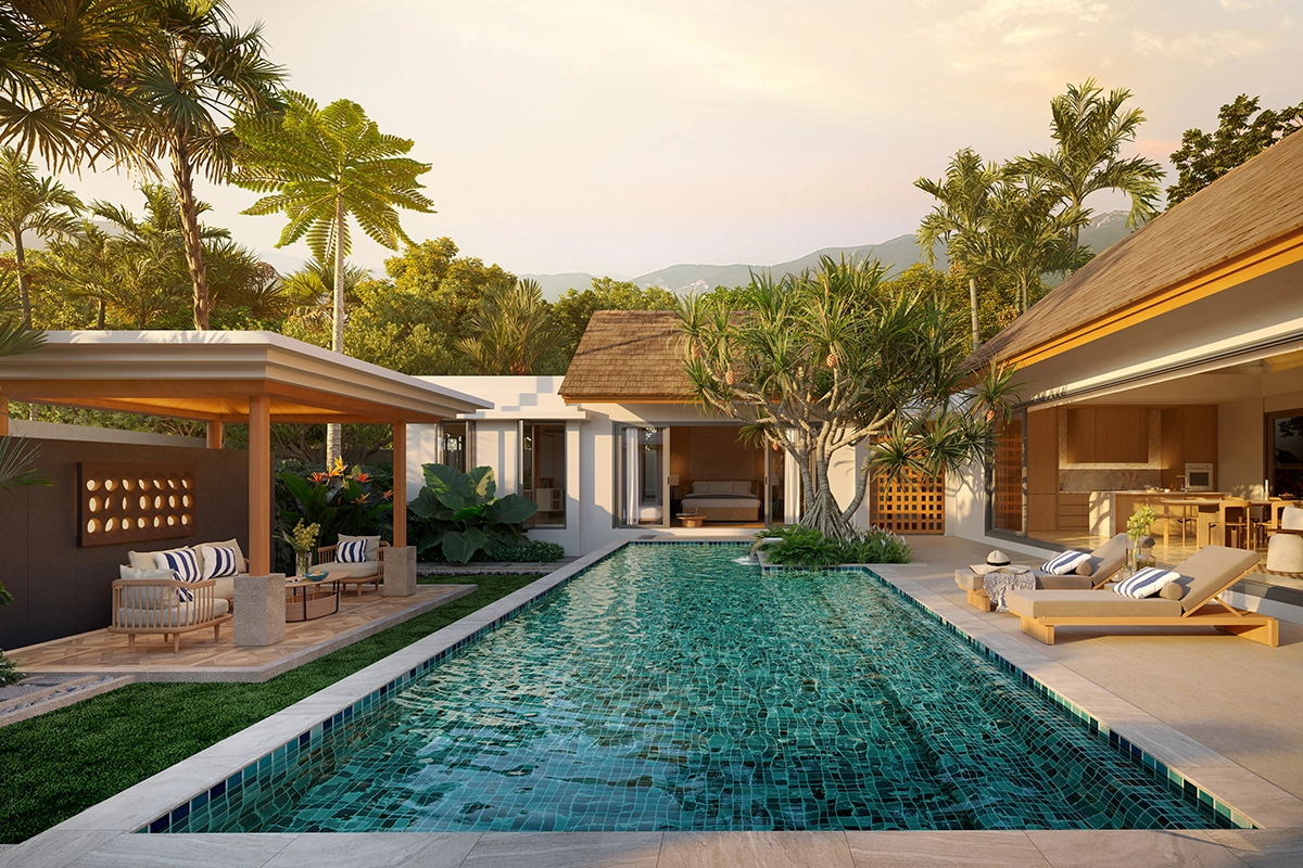 The pool courtyard in evening light: a pavilion with armchairs on the left, loungers and the open kitchen on the right, a bedroom with its wall slid open at the far end, mountains behind the trees