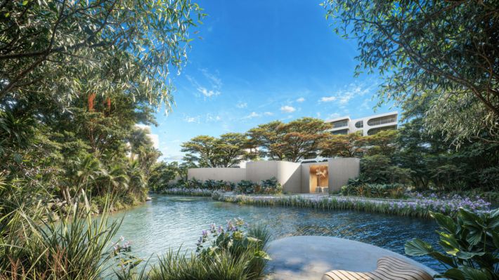 The lagoon amid dense planting, with a low white pavilion at the water's edge