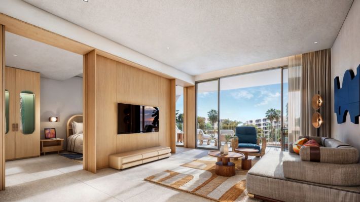 The one-bedroom: the living room, with the TV on the partition that screens the bedroom behind it