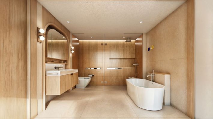 Bathroom of the 2 Bed-M: a glazed walk-in shower, a freestanding tub and a vanity under an arched mirror