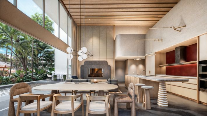 The duplex: a double-height living and dining area with a kitchen island and a fireplace on the far wall